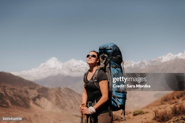 hiker on peak, annapurna circuit, the himalayas, dhaulagiri and tukuche mountains in background, muktinath, nepal - himalayas stock pictures, royalty-free photos & images