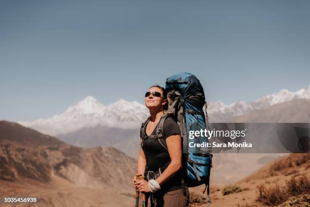 hiker on peak, annapurna circuit, the himalayas,  dhaulagiri and tukuche mountains in background, muktinath, nepal - nepal pokhara stock pictures, royalty-free photos & images