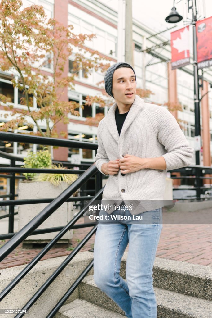 Young man walking down stairs, Yaletown, Vancouver, Canada