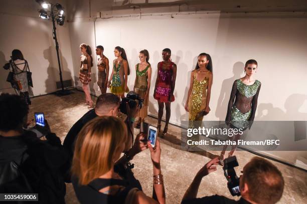 Models pose at the Mark Fast DiscoveryLAB during London Fashion Week September 2018 at the BFC Designer Showrooms on September 18, 2018 in London,...