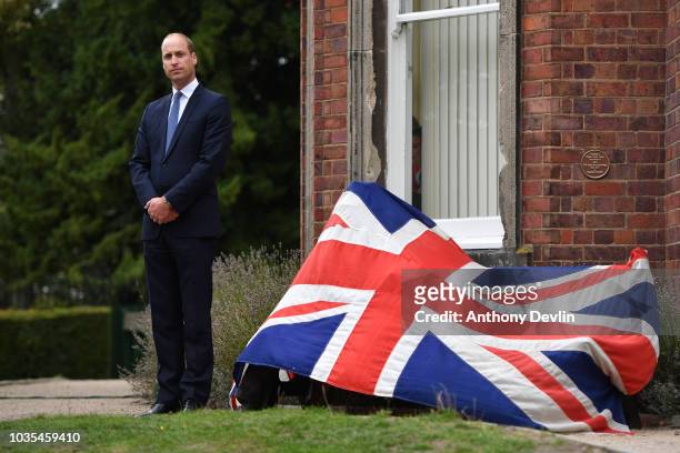 Prince William, Duke of Cambridge listens to a speech by Ian Austin MP before unveiling a new sculpture of Major Frank Foley by artist Andy de Comyn...