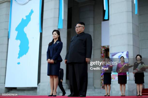 North Korea's leader Kim Jong Un and his wife Ri Sol Ju wait for South Korean President Moon Jae-in at Pyongyang Grand Theater on September 18, 2018...