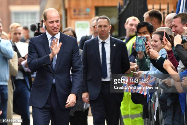 Prince William, Duke of Cambridge waves to members of the public after unveiling a new sculpture of Major Frank Foley by artist Andy de Comyn on...