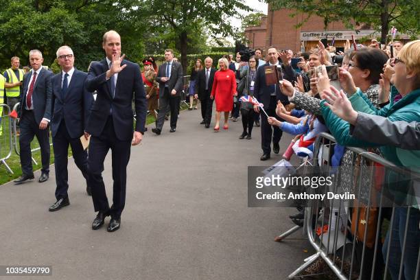 Prince William, Duke of Cambridge waves to members of the public after unveiling a new sculpture of Major Frank Foley by artist Andy de Comyn on...