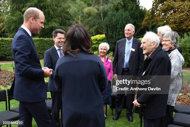 Prince William, Duke of Cambridge speaks with families of those helped by Major Frank Foley before unveiling a new sculpture of Major Foley by artist...