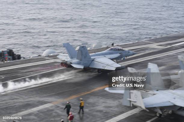 In this handout provided by the U.S. Navy, an F/A-18F Super Hornet assigned to the Red Rippers of Strike Fighter Squadron 11 takes off from the...