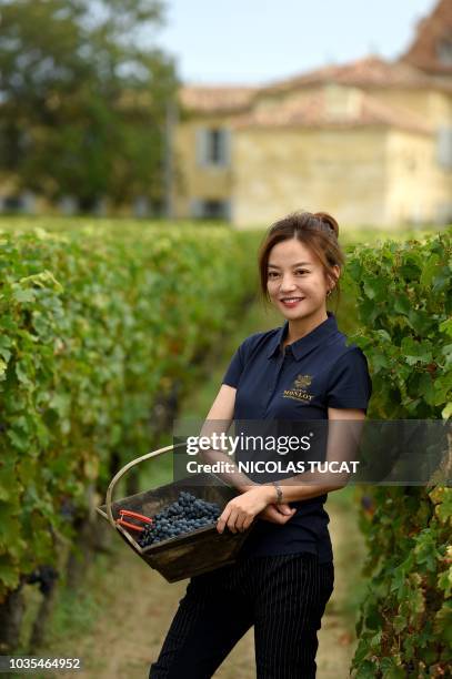 Chinese singer and actress Zhao Wei poses on September 18, 2018 in Saint-Hippolyte, southwestern France, in her vineyard of Chateau Monlot which is...