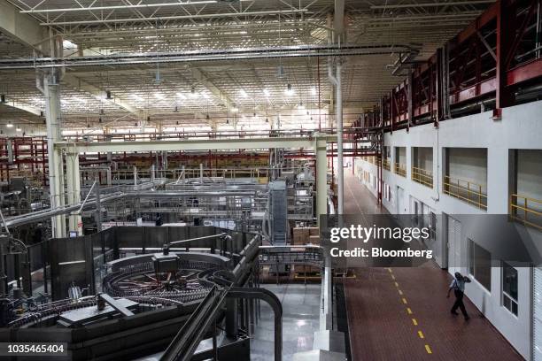 Worker walks through the production facility at Cerveceria Yucateca Anheuser-Busch InBev SA in Merida, Mexico, on Tuesday, Sept. 11, 2018. Grupo...