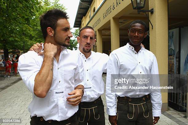 David Alaba of Bayern Muenchen arrives with his team mates Franck Ribery and Diego Contento for the Paulaner photocall at the Nockerberg Biergarden...