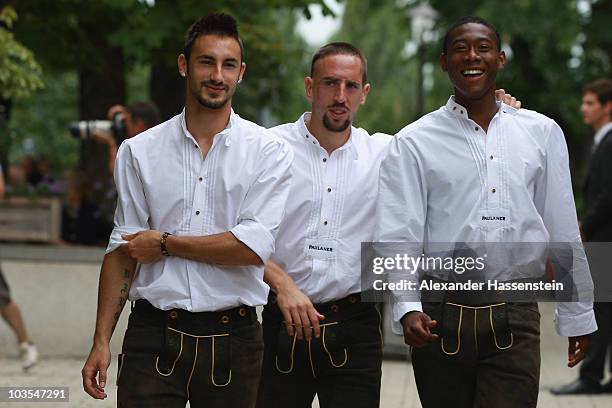 David Alaba of Bayern Muenchen arrives with his team mates Franck Ribery and Diego Contento for the Paulaner photocall at the Nockerberg Biergarden...
