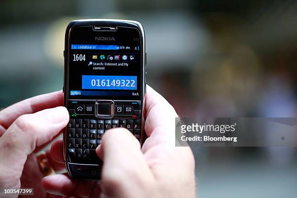 Businessman dials a telephone number on a Nokia E71 smartphone made by Nokia Oyj in this arranged photograph in London, U.K., on Thursday, Aug.19,...