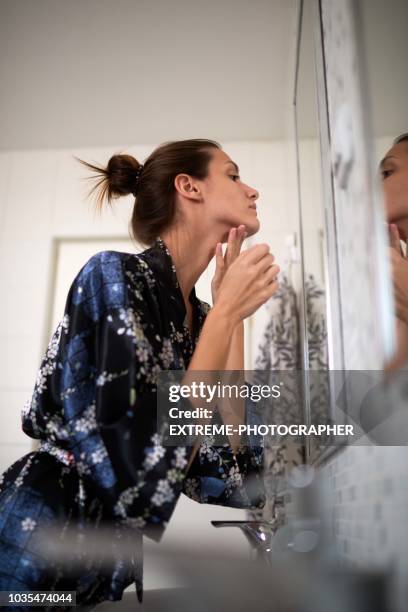 woman in the bathroom - removing make up stock pictures, royalty-free photos & images