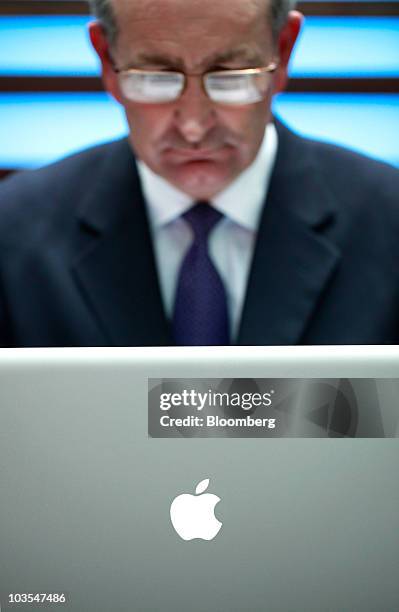 Businessman uses an Apple Macbook Pro laptop computer, made by Apple Inc., to surf the web in this arranged photograph in London, U.K., on Thursday,...