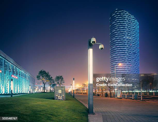 futuristic lit building and surveillance camera's - led street lighting stock-fotos und bilder