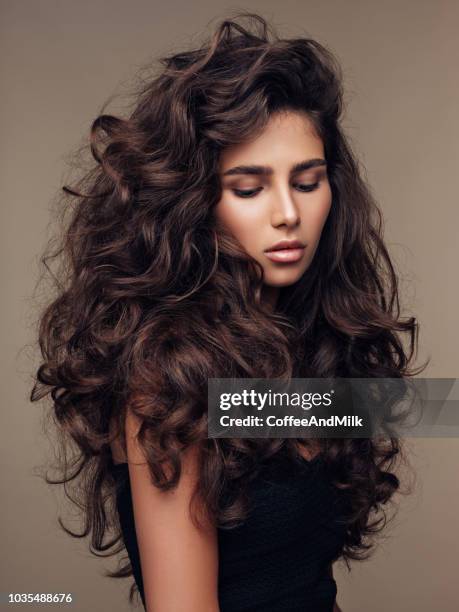 beautiful girl with lush curly hairstyle - curly brown hair stock pictures, royalty-free photos & images