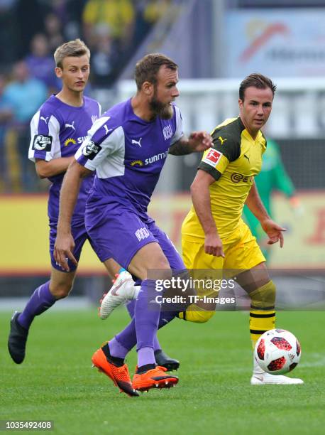 Felix Schiller of Osnabrueck and Mario Goetze of Borussia Dortmund battle for the ball during the Frendly Match between VfL Osnabrück and Borussia...