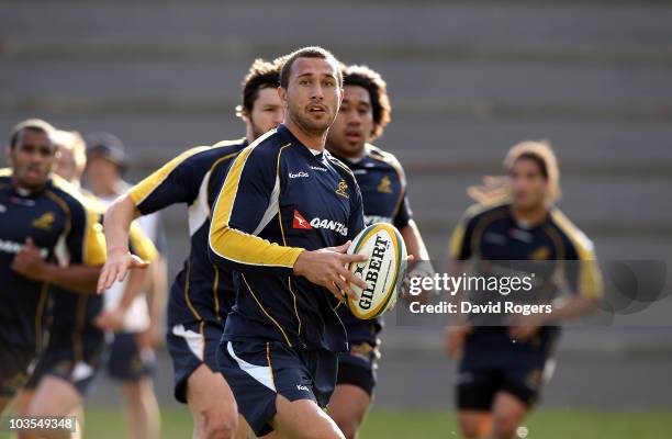 Quade Cooper runs with the ball during an Australian Wallabies training session Bishops High School on August 23, 2010 in Cape Town, South Africa.