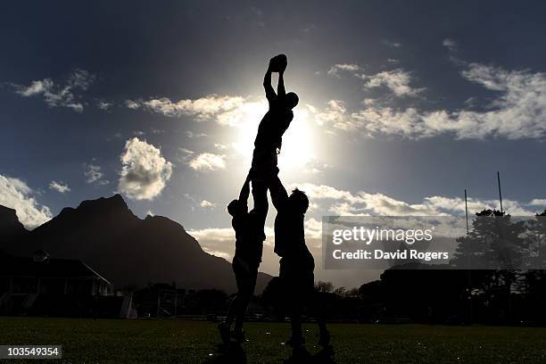 Silhouette of Nathan Sharpe catching the ball during an Australian Wallabies training session Bishops High School on August 23, 2010 in Cape Town,...