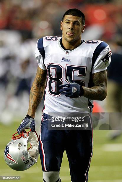 Tight end Aaron Hernandez of the New England Patriots jogs off of the field during halftime during the preseason game against the Atlanta Falcons at...