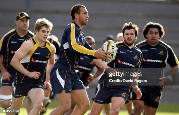 Quade Cooper runs with the ball during an Australian Wallabies training session Bishops High School on August 23, 2010 in Cape Town, South Africa.