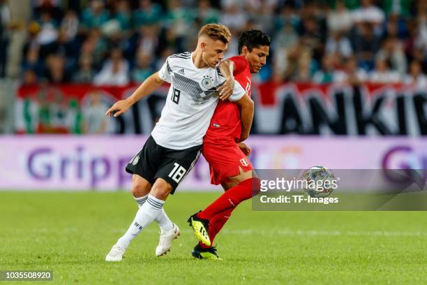 Joshua Kimmich of Germany and Raul Ruidiaz of Peru battle for the ball during the International Friendly match between Germany and Peru on September...