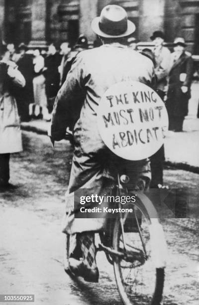 Supporter of King Edward VIII at the time of his abdication wears a placard reading 'The King must not abdicate', December 1936. The King was in...