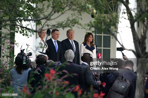 President Donald Trump , first lady Melania Trump , President Andrzej Sebastian Duda of Poland and his wife Agata Kornhauser-Duda stop to pose for...