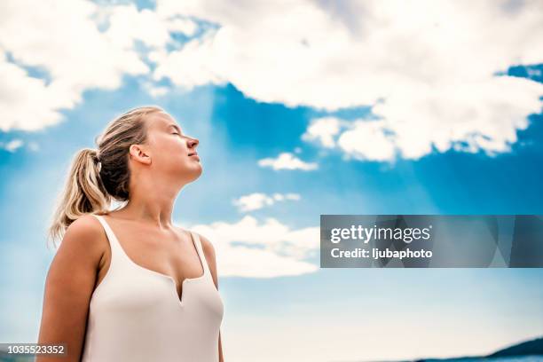 portrait de femme de respirer profondément l'air sur la plage - woman fresh air photos et images de collection