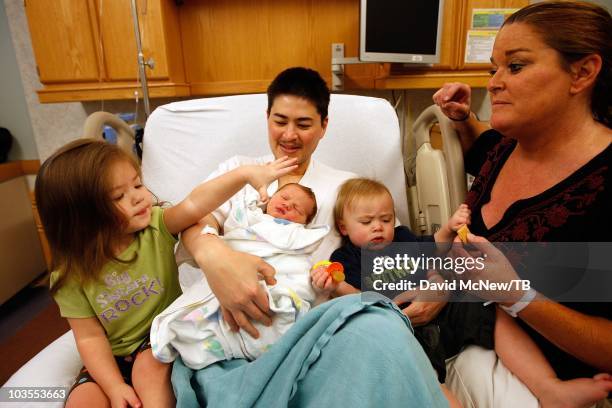 Thomas Beatie, a transgender male, enjoys his new son Jensen James Beatie on the day after giving birth to him with his wife Nancy by his side at...