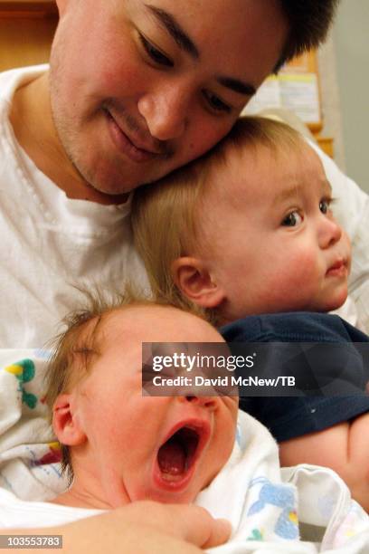 Thomas Beatie, a transgender male, enjoys his new son Jensen James Beatie on the day after giving birth to him with his wife Nancy by his side at...