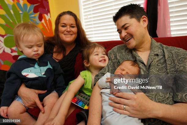 Thomas Beatie, a transgender male, holds his new son Jensen James Beatie with his wife Nancy after returning home from Saint Charles Medical Center...