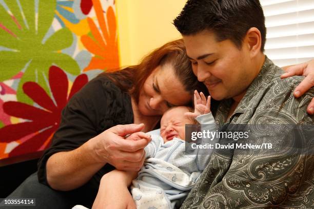 Thomas Beatie, a transgender male, holds his new son Jensen James Beatie with his wife Nancy after returning home from Saint Charles Medical Center...