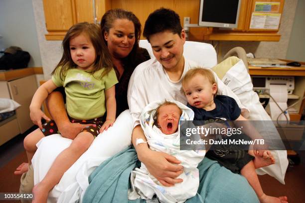 Thomas Beatie, a transgender male, enjoys his new son Jensen James Beatie on the day after giving birth to him with his wife Nancy by his side at...