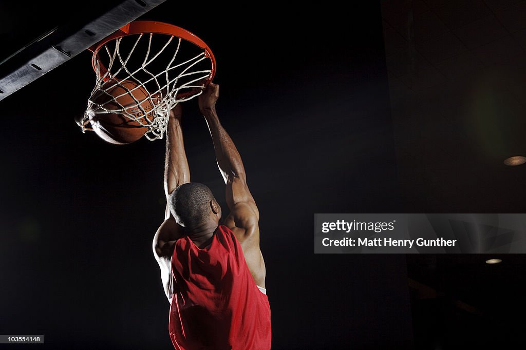 Man dunking basketball
