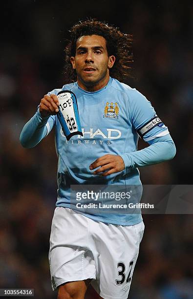 Carlos Tevez of Manchester City celebrates the third goal with James Milner goal during the Barclays Premier League match between Manchester City and...