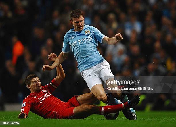 Steven Gerrard of Liverpool battles with James Milner of Manchester City during the Barclays Premier League match between Manchester City and...
