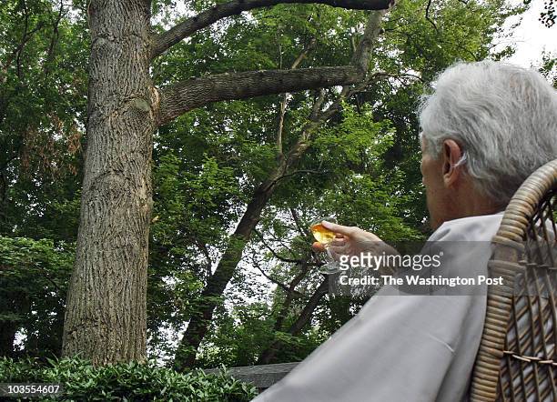 The O'Connors, Pat and Chuck, hold a farewell ceremony for the beloved tulip poplar in their back yard, struck by lightning and condemned by...