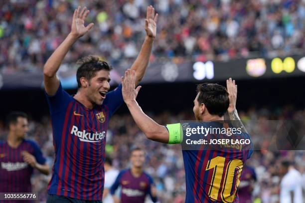 Barcelona's Argentinian forward Lionel Messi celebrates with Barcelona's Spanish midfielder Sergi Roberto after scoring during the UEFA Champions'...