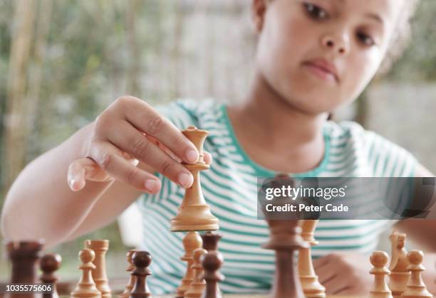 girl playing chess - kids playing chess stock pictures, royalty-free photos & images