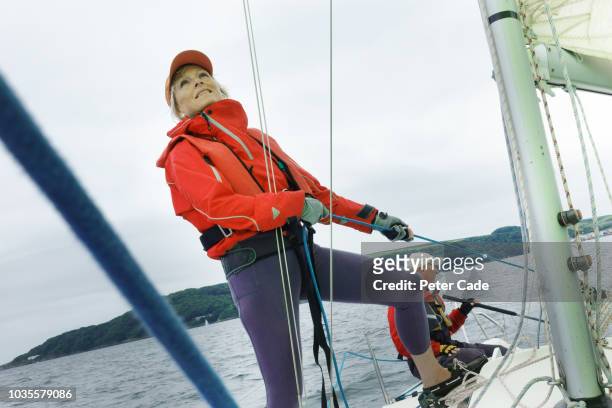 mature couple sailing boat - captain yacht stockfoto's en -beelden