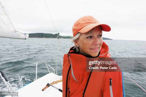 mature lady on sailing boat - steuerruder stock-fotos und bilder