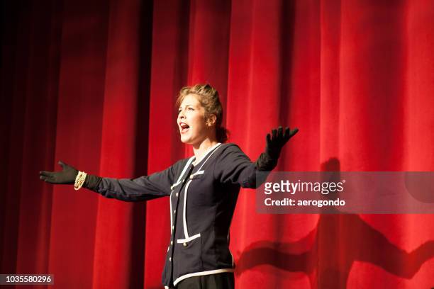 actress by red curtain performing - atriz imagens e fotografias de stock