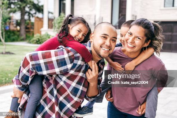 family with two kids looking at camera - family filipino stock pictures, royalty-free photos & images