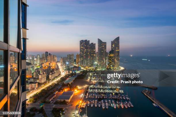 busan city skyline view at haeundae district, gwangalli beach with yacht pier at busan, south korea. - south stock-fotos und bilder