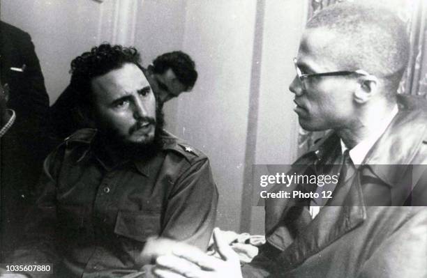 Photograph of a meeting in Harlem with Fidel Castro and Malcolm X . Dated 1960.