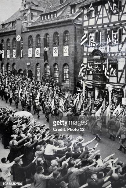 Armed forces Day in Nuremberg Soldiers parade while onlookers give Nazi salute.