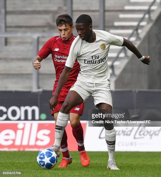 Adam Lewis of Liverpool and Cawdy Williams of Paris Saint-Germain in action during the UEFA Youth League game at Langtree Park on September 18, 2018...