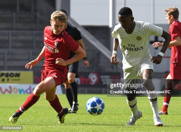 Paul Glatzel of Liverpool and Raphael Nya of Paris Saint-Germain in action during the UEFA Youth League game at Langtree Park on September 18, 2018...