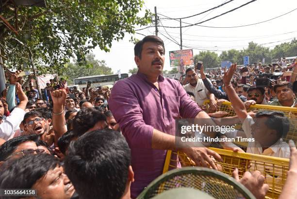 Police try to stop BJP President Manoj Tiwari as he attempts to break the seal of a property sealed by MCD in Gokulpuri area, on September 18, 2018...