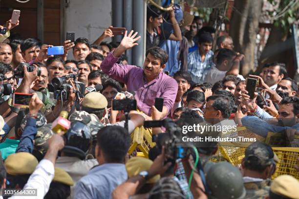 Police try to stop BJP President Manoj Tiwari as he attempts to break the seal of a property sealed by MCD in Gokulpuri area, on September 18, 2018...